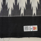 Close-up of the luxurious Berhampuri Silk Saree fabric, revealing the fine weave and soft texture.
