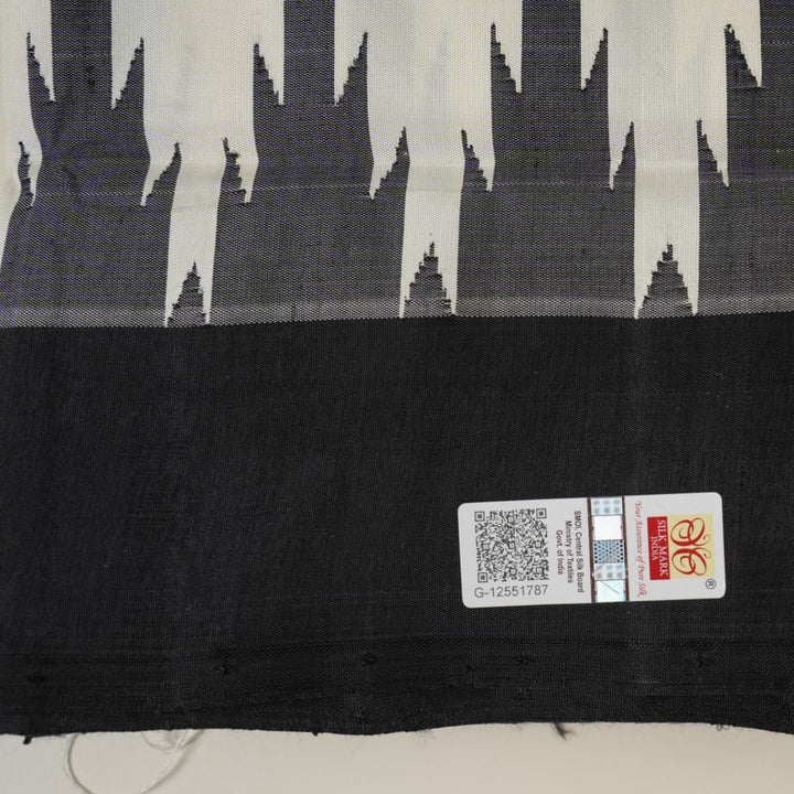 Close-up of the luxurious Berhampuri Silk Saree fabric, revealing the fine weave and soft texture.