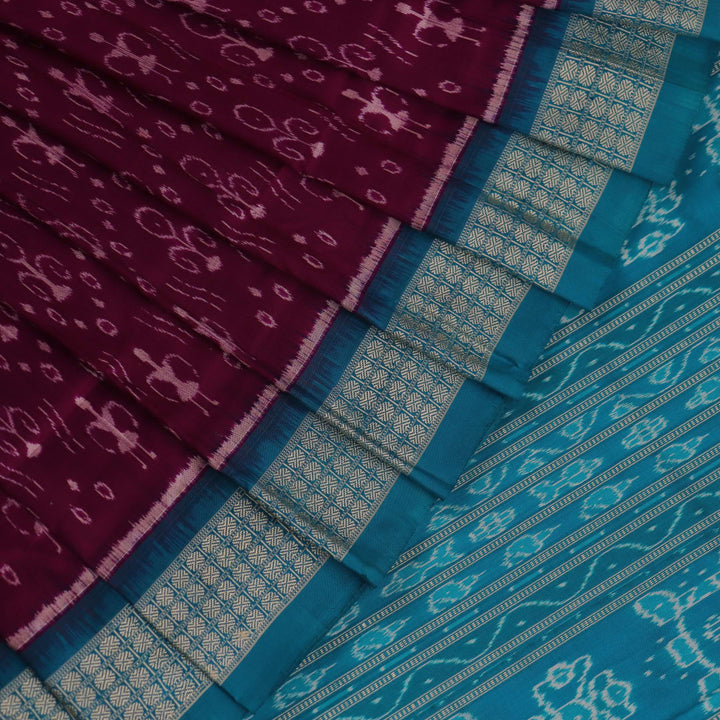 Close-up showcasing the purple and blue silk fabric texture of the Sambalpuri saree with intricate motifs.