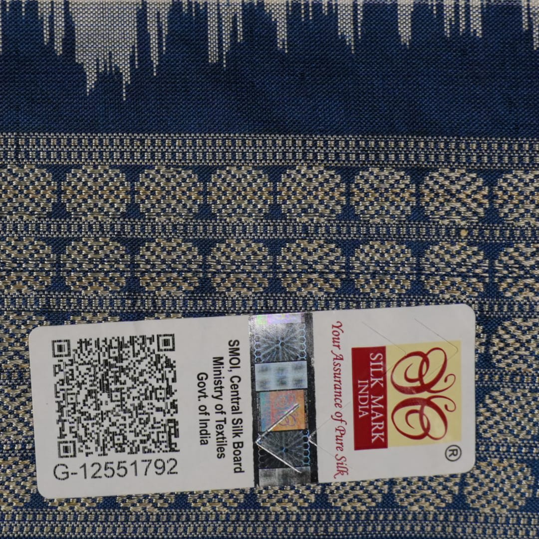 Close-up of premium fabric texture and handloom weave on a white and blue Sambalpuri silk saree