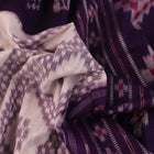 Elegantly draped red and violet Sambalpuri cotton saree with traditional motifs.
