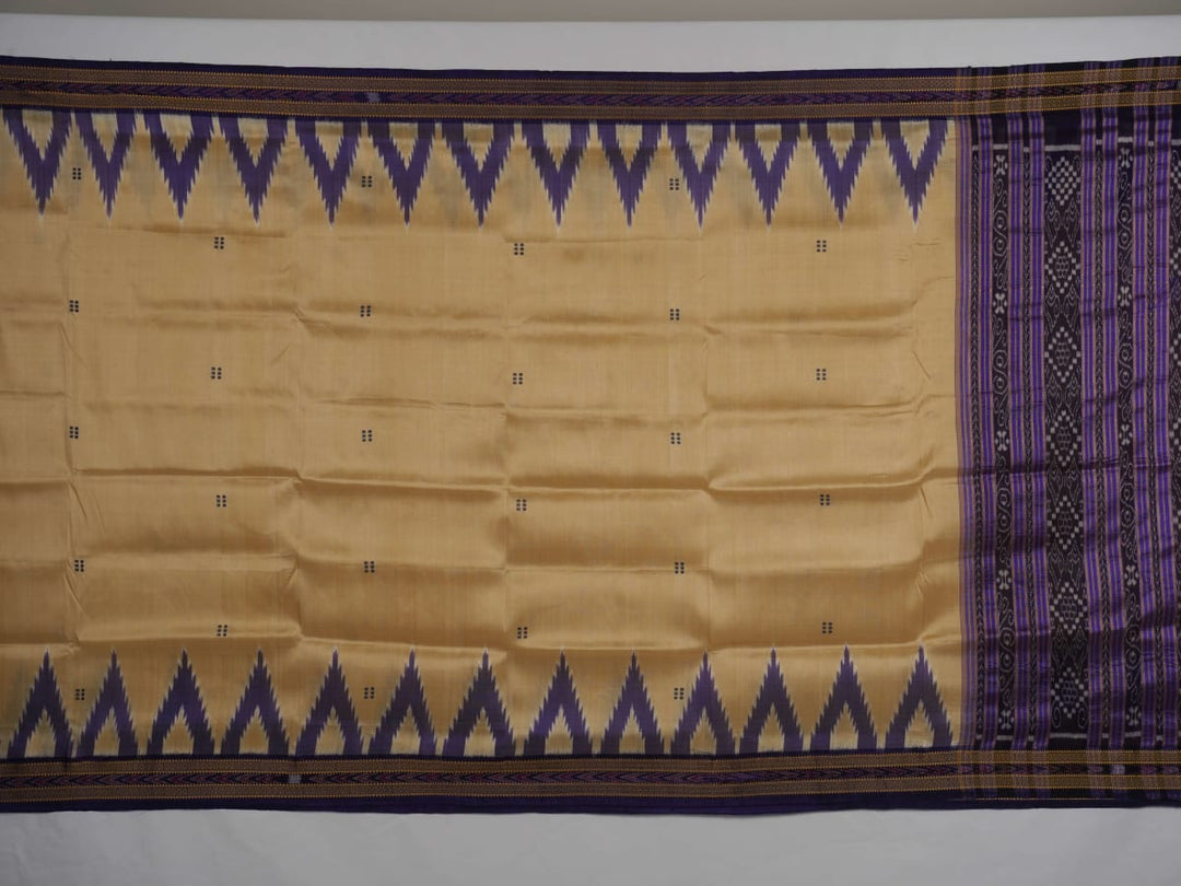 Model draped in a cream and blue Khandua silk saree with butta patterns, showcasing traditional styling.