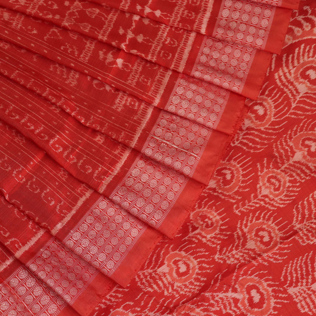 Close-up showcasing the intricately woven silk fabric texture of a multi-colored Sambalpuri saree with traditional motifs.