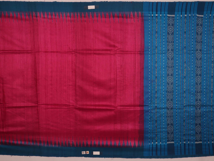 Close-up shot showcasing the textured weave of the tussar silk fabric of a plain pink and blue saree.