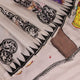 Close-up of white silk Patachitra saree fabric showing hand-painted texture and detail.