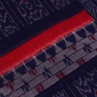 Blue Sambalpuri cotton saree with motifs, gracefully draped.