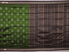 Close-up view of the silken texture of the Sambalpuri silk saree, showcasing green and black woven motifs.