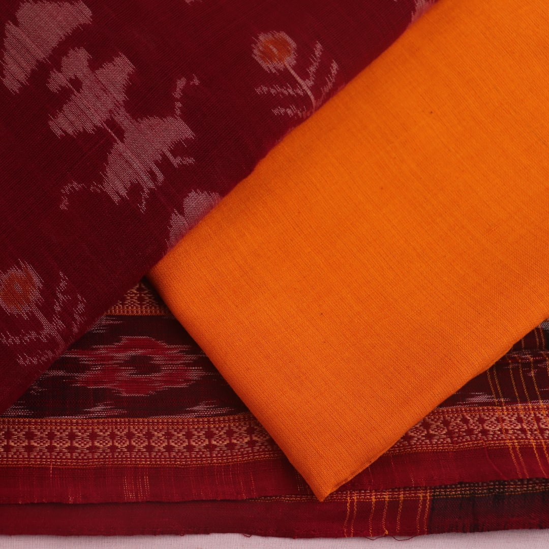 Maroon and yellow Sambalpuri cotton dress material blouse piece with motifs.