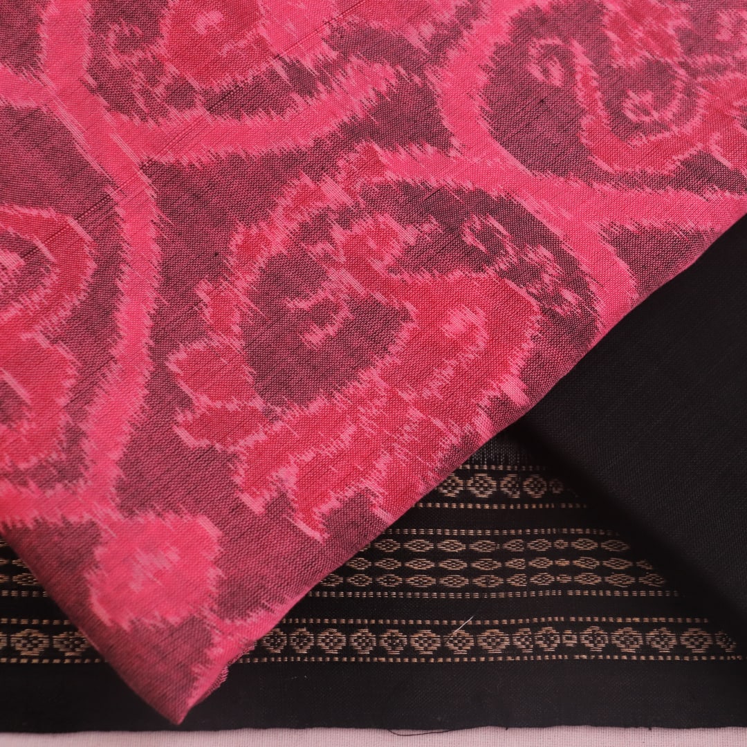 Detail of the pink and black Sambalpuri cotton dress material's blouse piece with motifs.