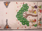Close-up of white silk Patachitra saree fabric showing hand-painted texture and detail.