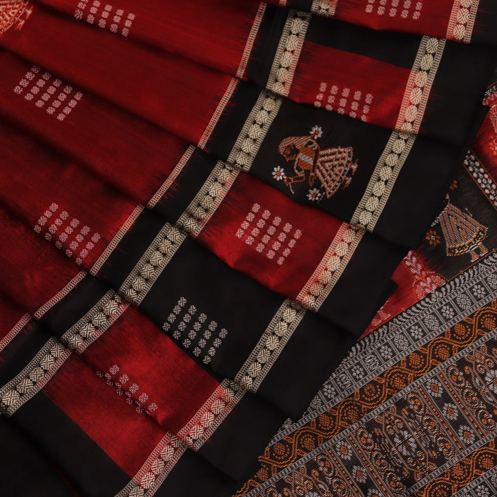 Close-up of maroon silk fabric with delicate butta patterns in black.