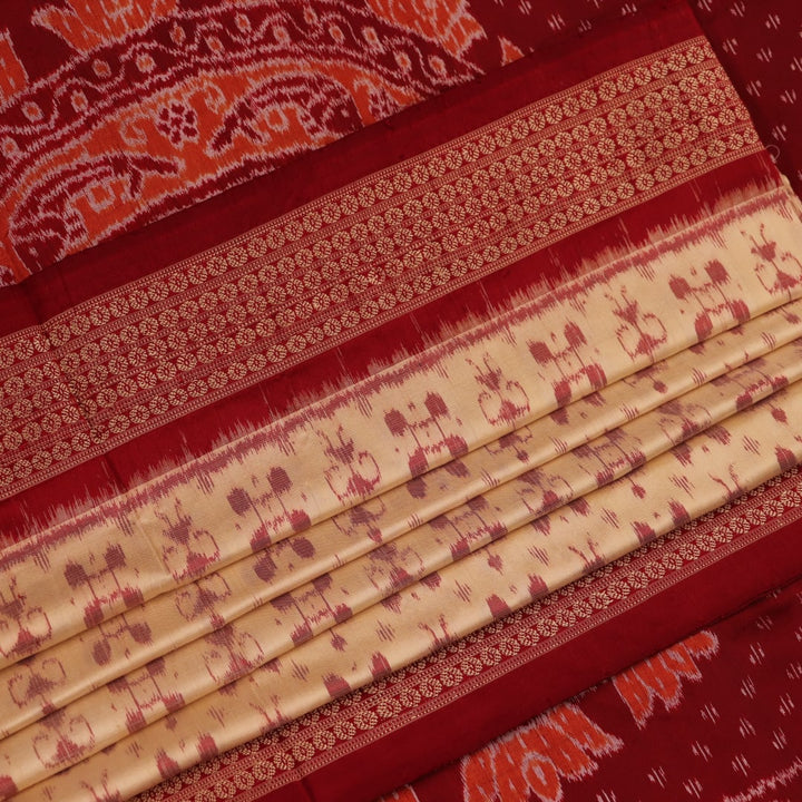 Close-up showcasing the intricate cream and maroon silk fabric texture with Sambalpuri motifs