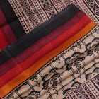 Close-up of off-white Tussar silk fabric, highlighting natural slubs and printed black pattern.