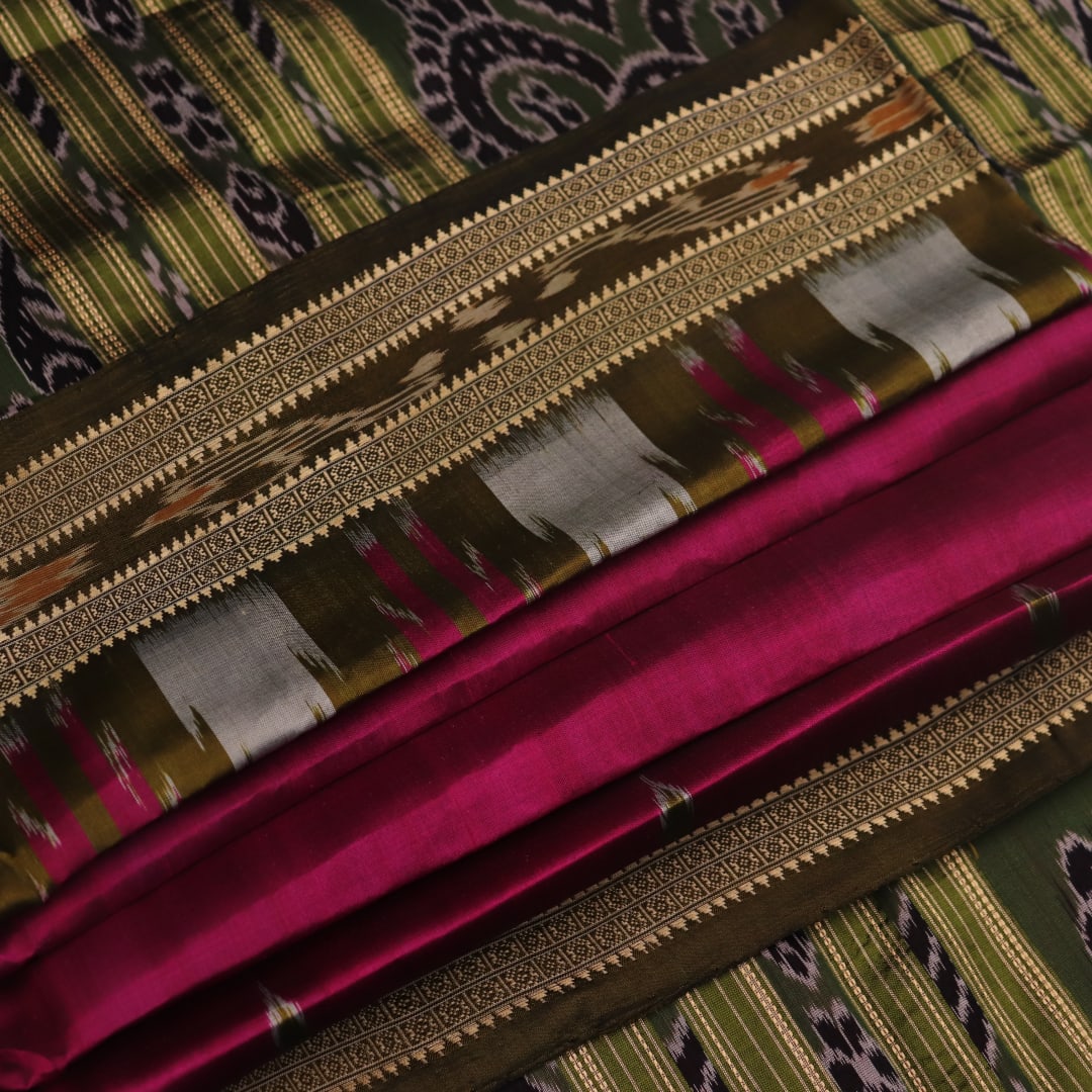 Magenta Khandua silk saree styled; green blouse accentuates the butta pattern and rich drape.