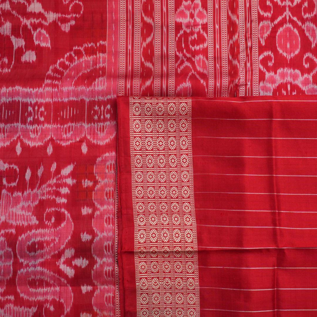 Close-up of the luxurious white Sambalpuri silk saree fabric, highlighting its rich texture and weave.