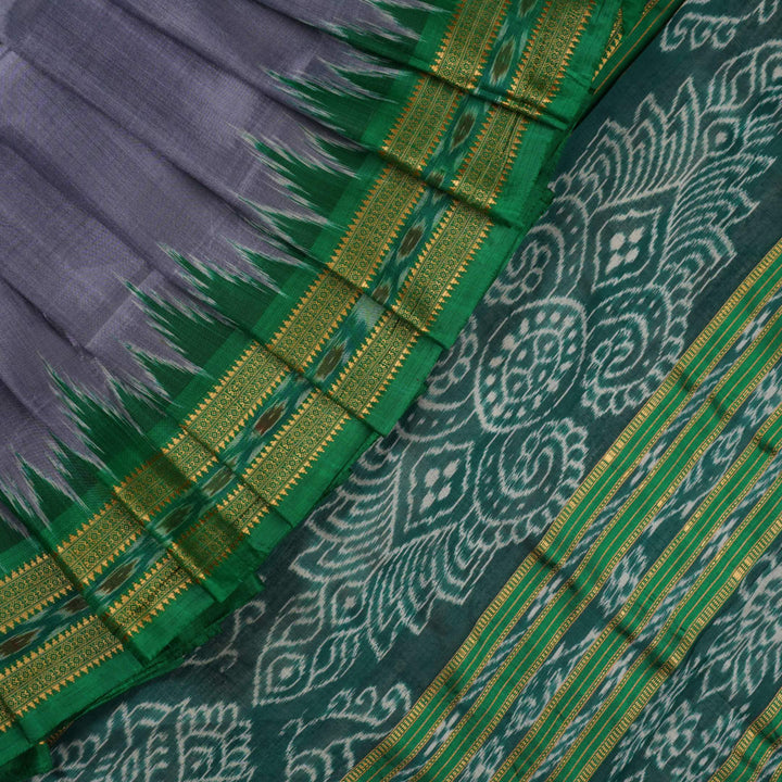 Model draped in a grey and green Khandua silk saree with butta pattern for a classic traditional look.