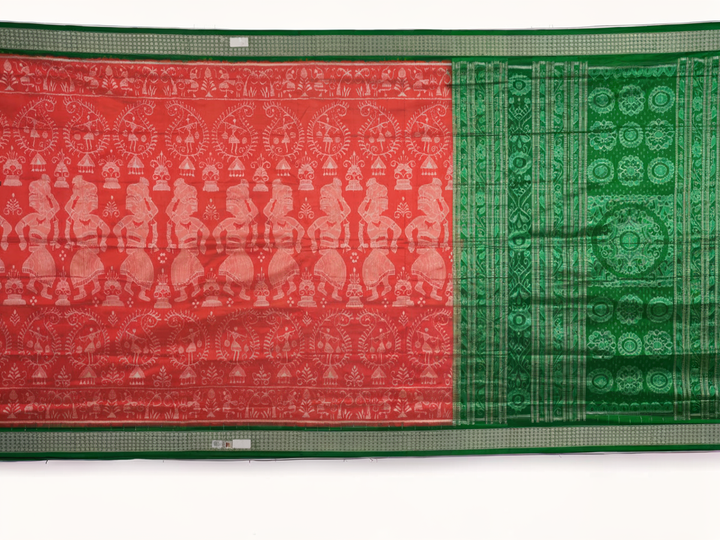 Close-up of the smooth, rich silk texture of the peach Sambalpuri saree with fine motifs.