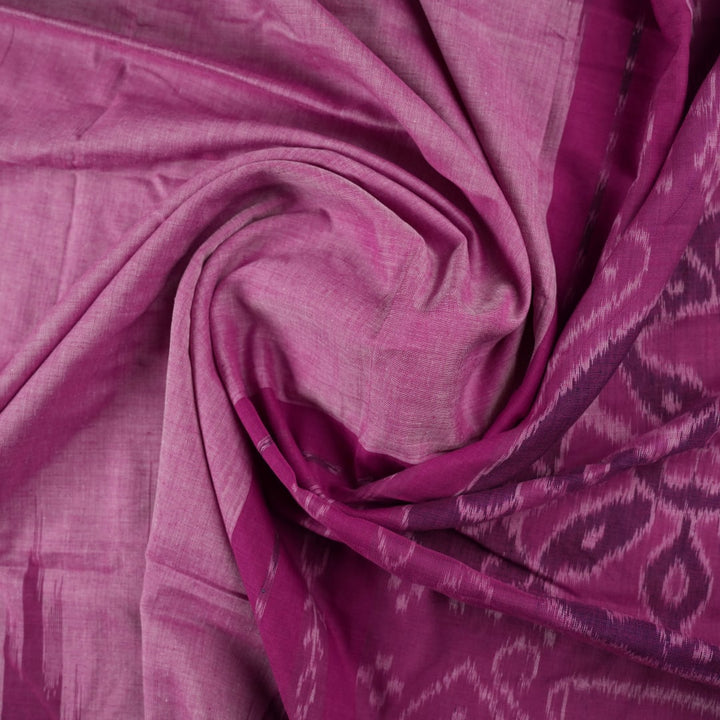 Model draped in a plain pink Sambalpuri cotton saree, styled to show the graceful fall and elegant border.