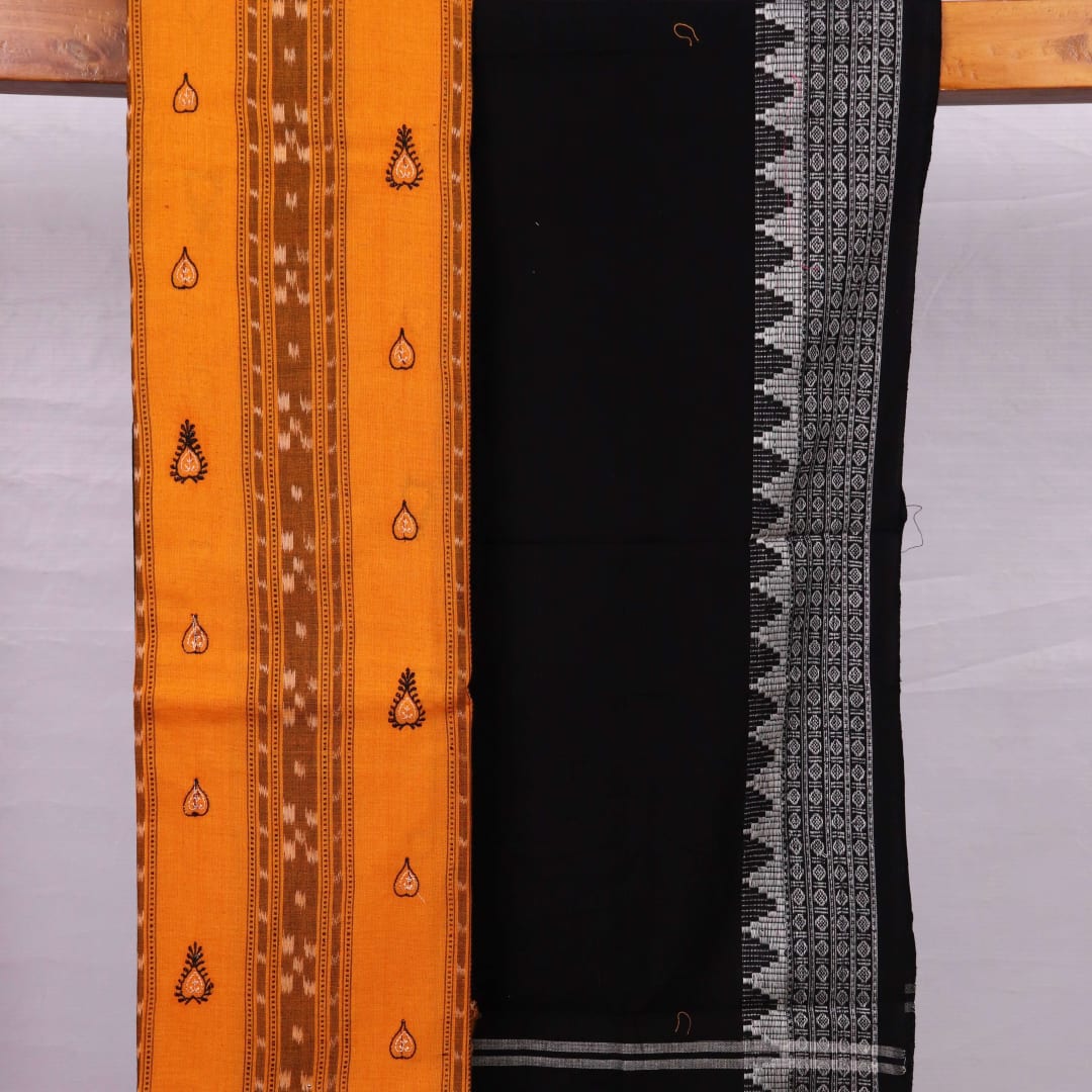 Close-up view of the blouse piece from a yellow and black cotton Sambalpuri dress material featuring motifs.