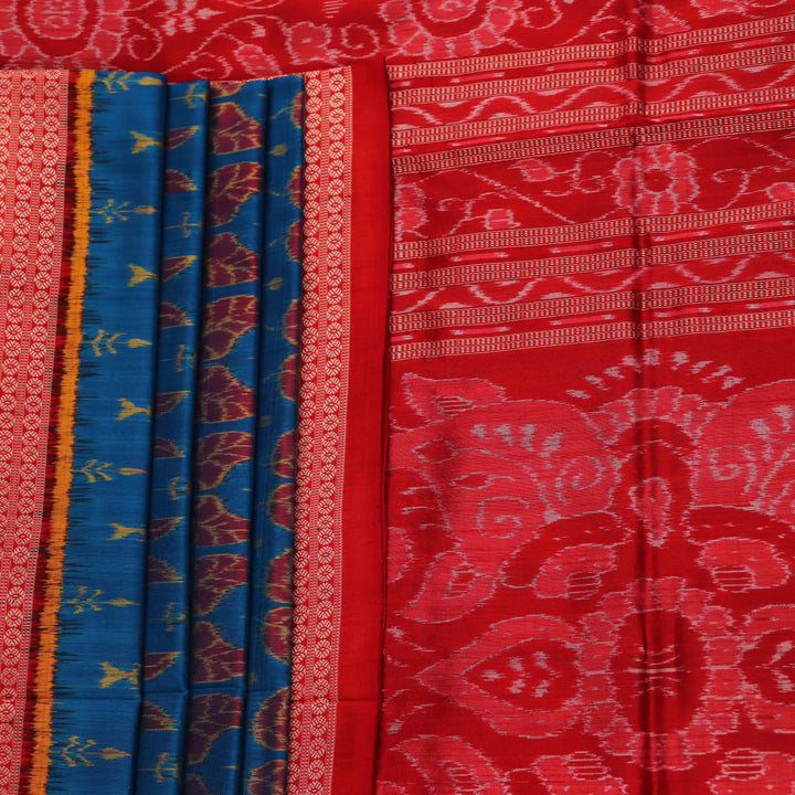 Close-up of blue and orange silk fabric texture with woven motifs