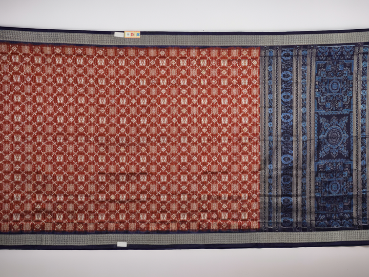 Close-up of the rich silk fabric texture of the Sambalpuri Saree, showing the intricate weave and slight sheen.