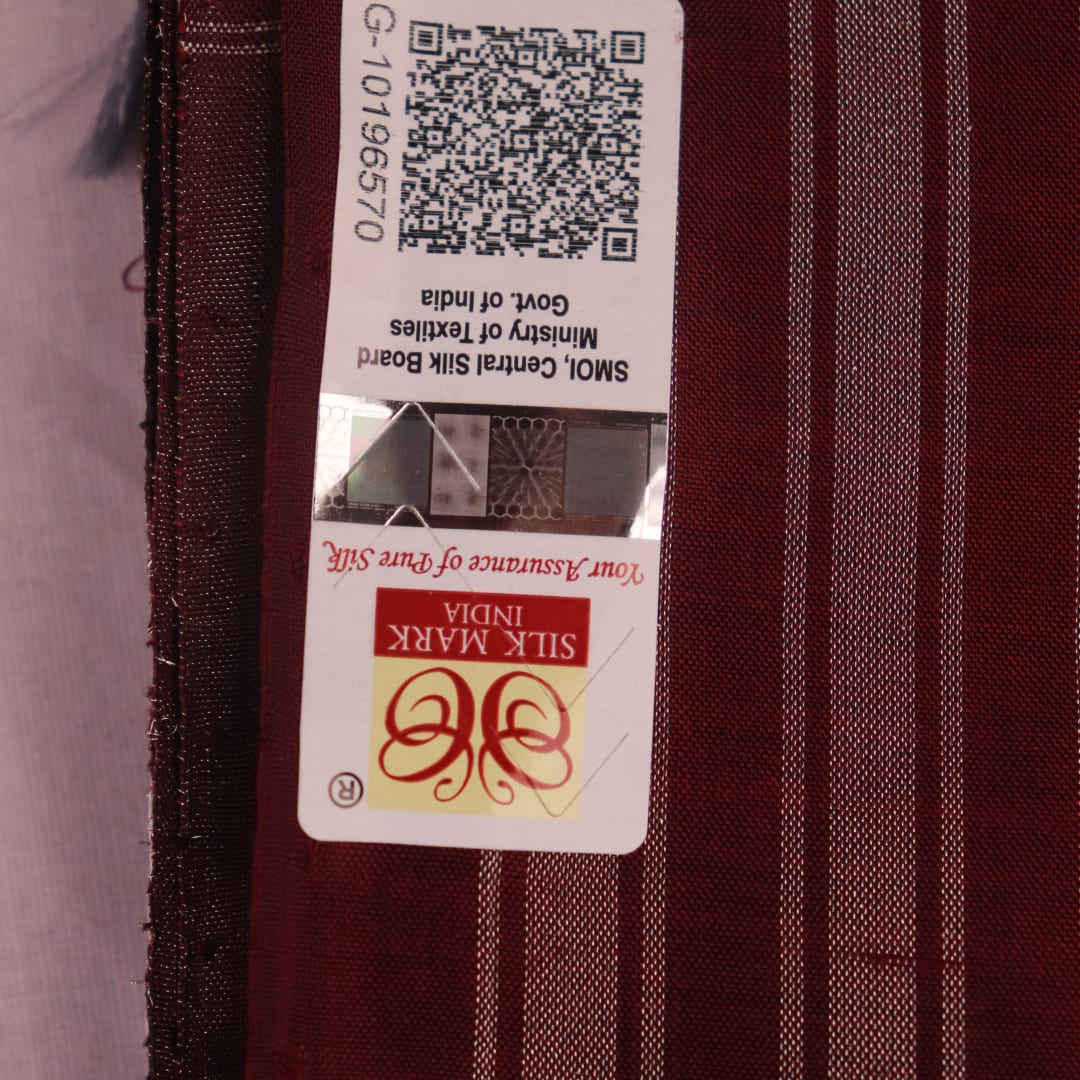 Close-up of grey and maroon Sambalpuri Silk Saree's butta pattern fabric texture.