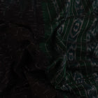 Black and green plain Sambalpuri cotton saree, gracefully draped.