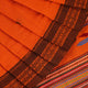 Full-length view of an orange cotton Berhampuri saree with a butta pattern and broad orange borders.