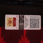 Textured close-up of red and black Sambalpuri Silk Saree fabric, highlighting the woven butta pattern.