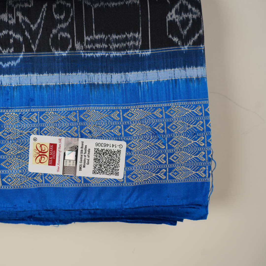 Close-up of Sambalpuri Silk saree fabric, revealing its rich texture and intricate black and blue weave.