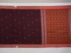 Full view of the maroon Bomkai cotton saree with red borders and small butta motifs laid out flat.