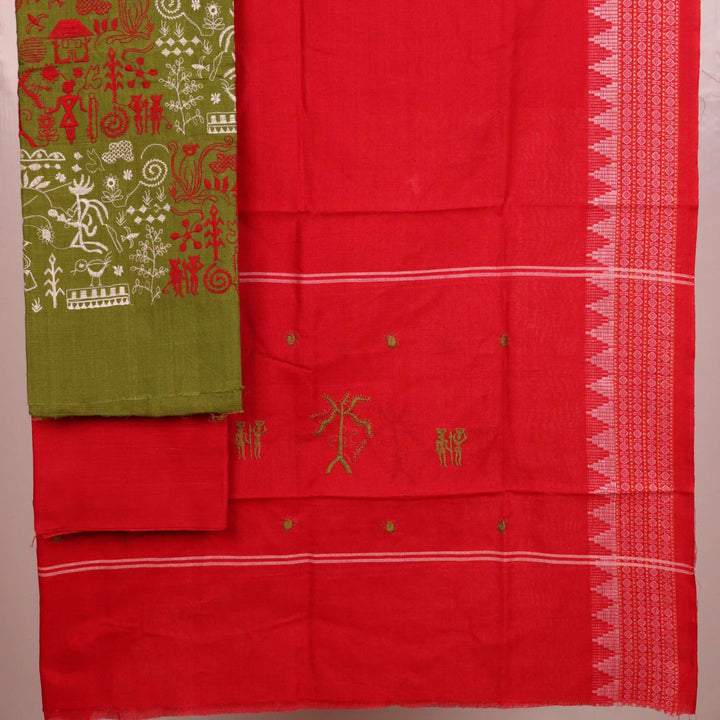 Close-up of a green cotton Sambalpuri dress material with a red doll pattern blouse piece.