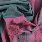 Full view of a plain handloom Sambalpuri cotton saree in green and peach.