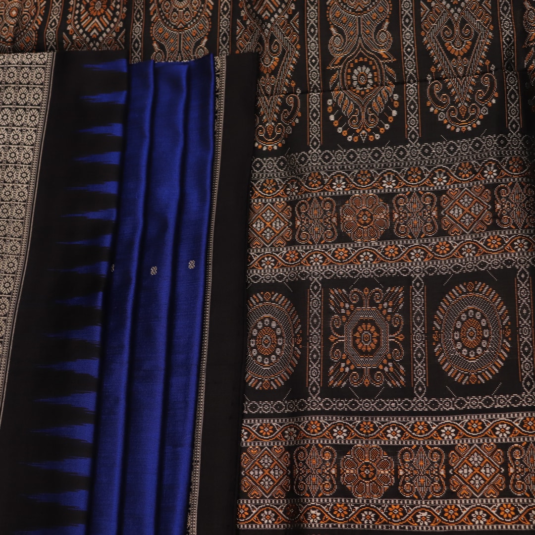 Close-up of the intricate woven texture of blue and black Bomkai silk saree with butta.
