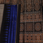 Close-up of the intricate woven texture of blue and black Bomkai silk saree with butta.