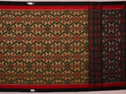 Green and black Sambalpuri cotton saree with motifs, elegantly draped for styling.