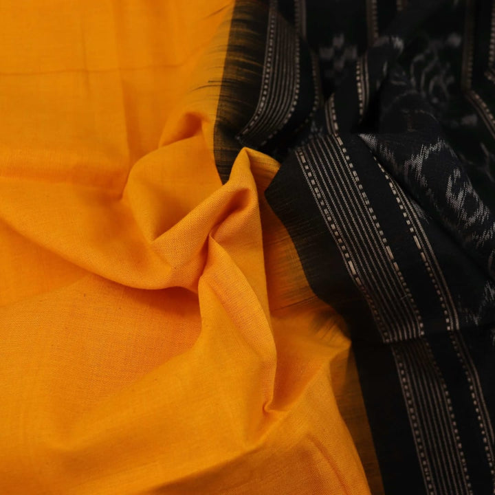 Yellow and black Sambalpuri cotton dupatta draped on a woman