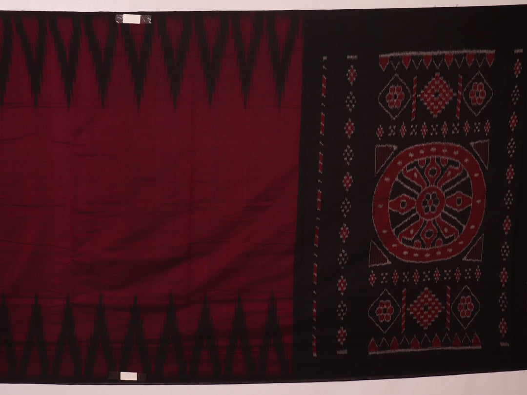 Plain maroon and black Sambalpuri cotton saree, elegantly draped.