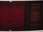 Plain maroon and black Sambalpuri cotton saree, elegantly draped.