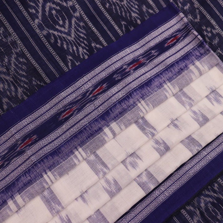 Model wearing a white Sambalpuri cotton saree with blue motifs, showcasing the drape and overall look.