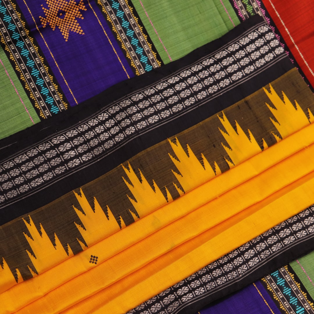 Close-up view of the golden silk fabric with black butta pattern of a Berhampuri silk saree