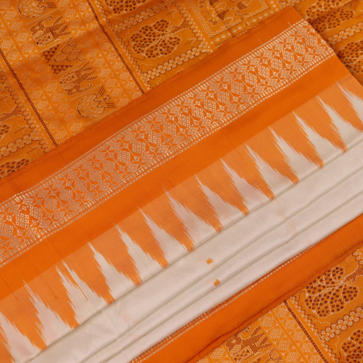 Close-up of Bomkai silk saree fabric texture in white with yellow butta pattern.