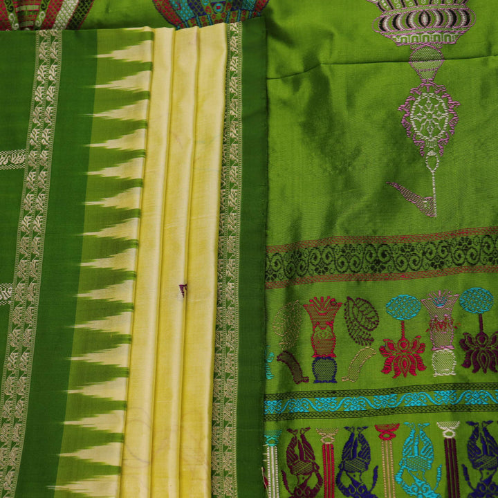 Close-up of cream and green Bomkai Silk Saree fabric texture with butta pattern.