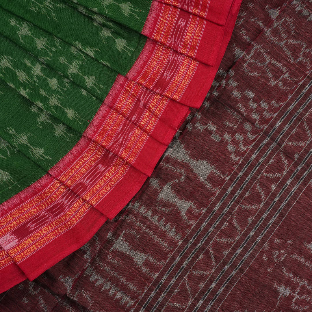 Model draped in a green and red Sambalpuri cotton saree with traditional motifs, styled for a classic look.