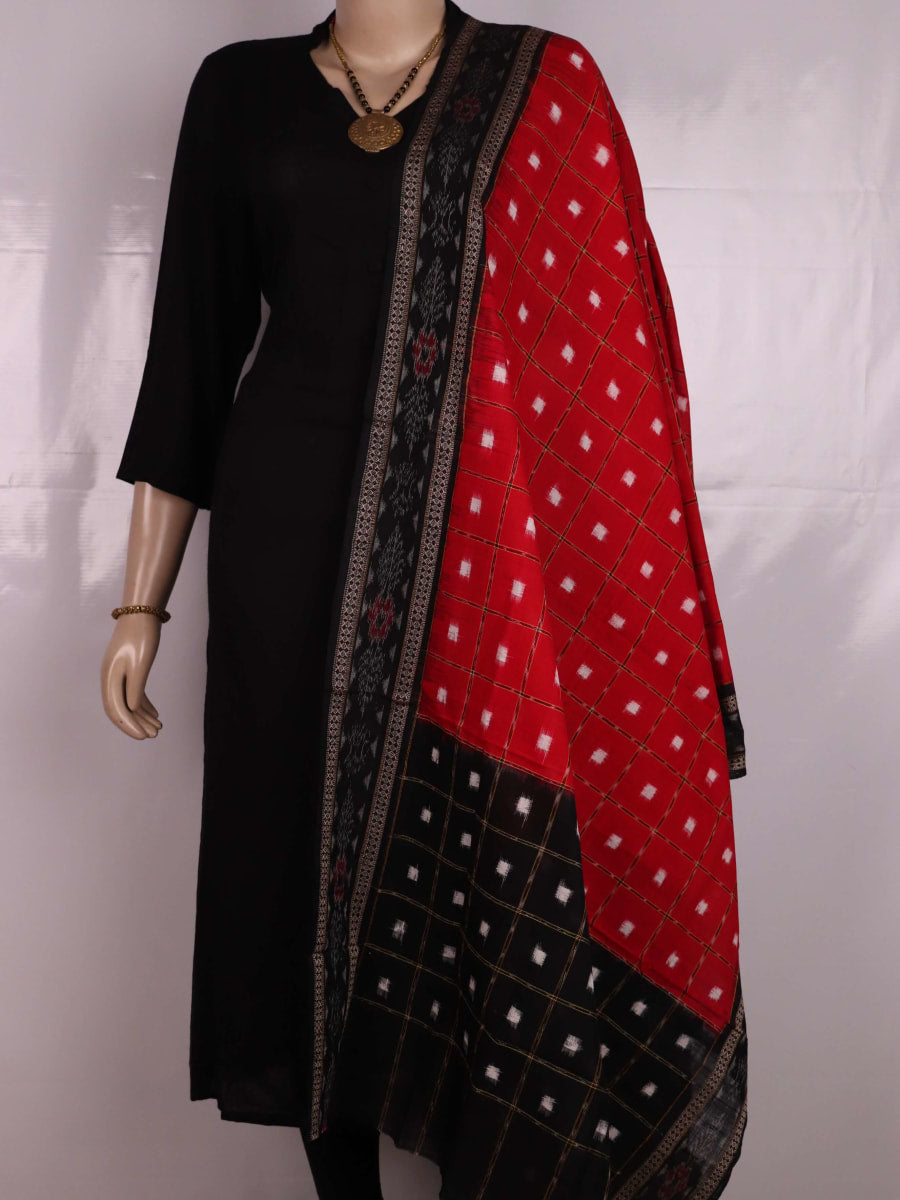Red and black Sambalpuri cotton dupatta with intricate motifs, styled elegantly