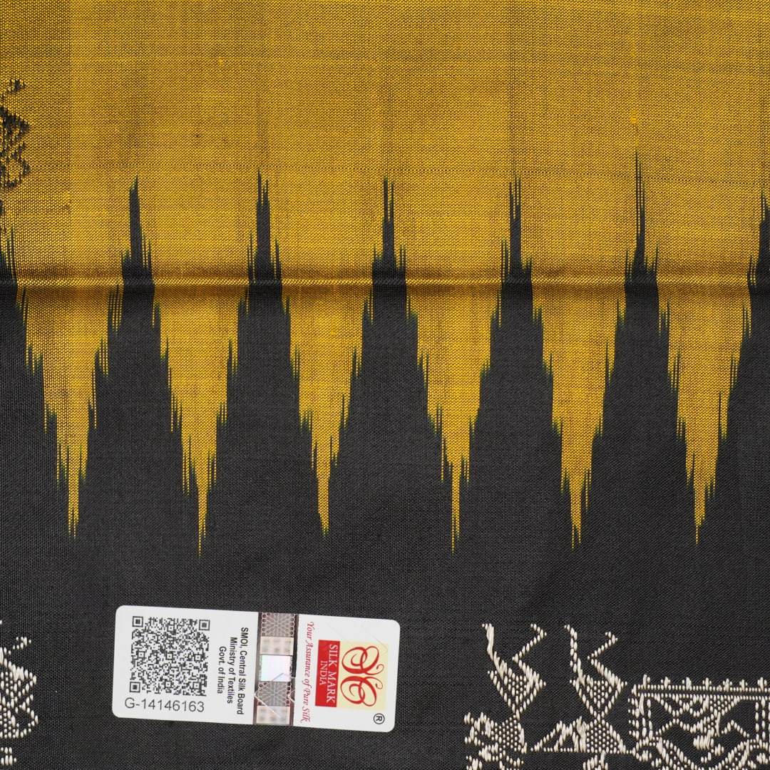 Macro close-up of Bomkai Silk Saree fabric, showing intricate brown & black silk weave.