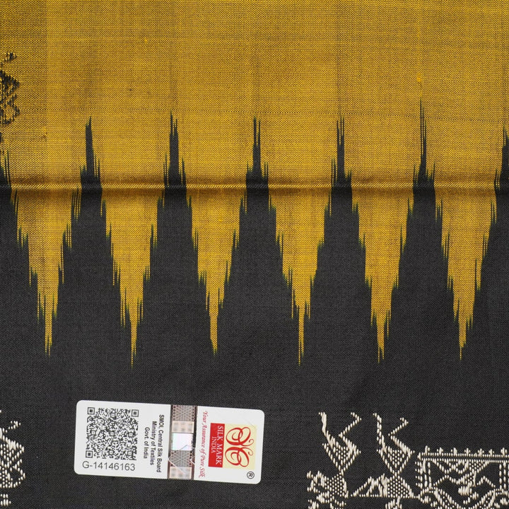 Macro close-up of Bomkai Silk Saree fabric, showing intricate brown & black silk weave.