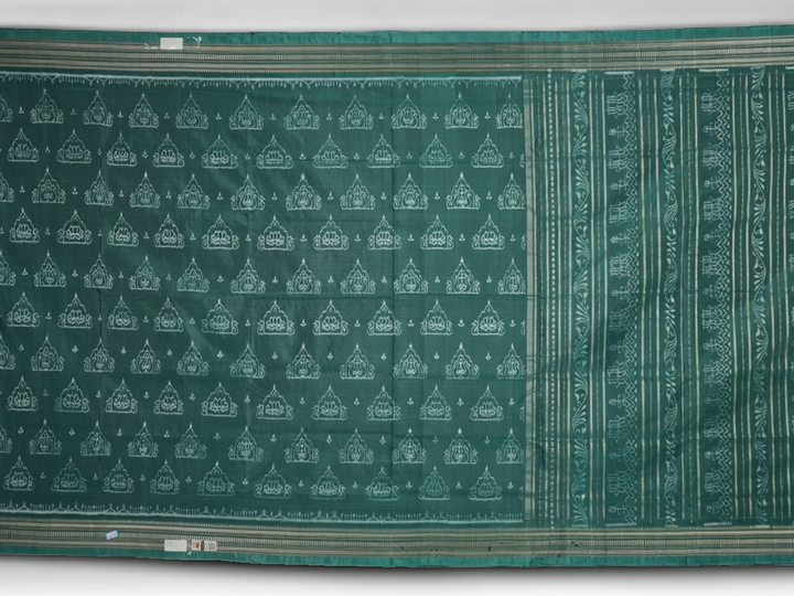Close-up of green Sambalpuri silk fabric, showing its luxurious texture and fine handloom weave.