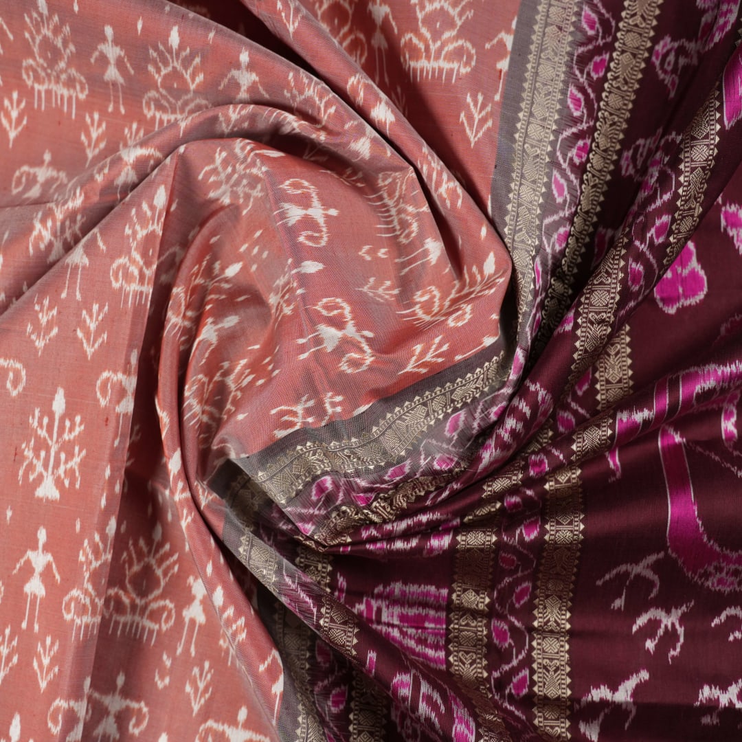 Close-up of the rich multi-color and maroon Sambalpuri silk fabric, highlighting its exquisite handloom weave texture.