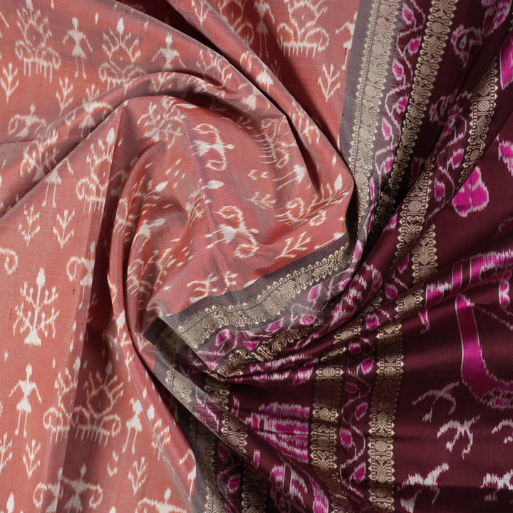Close-up of the rich multi-color and maroon Sambalpuri silk fabric, highlighting its exquisite handloom weave texture.